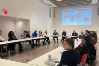 Group of adults sit at a roundtable at the Center for Architecture.